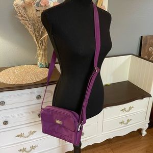 Travelon small purse. Purplish color. Good used condition. Crossbody